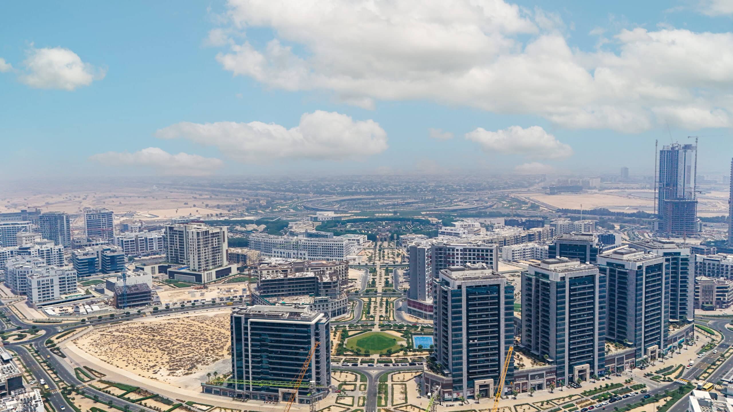 Aerial view of the Arjan district in Dubai, one of the best areas to buy apartments in 2026, with modern high-rise residential buildings