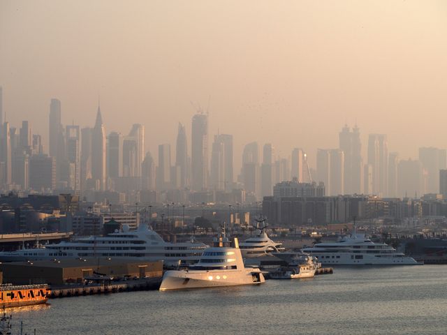 Dubai skyline and marina at sunset with high-rise apartment towers overlooking the harbour